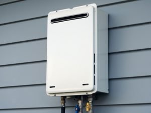 Tankless water heater installation on exterior wall, showcasing plumbing connections, relevant to Great American Plumbing services in Plantation, FL.