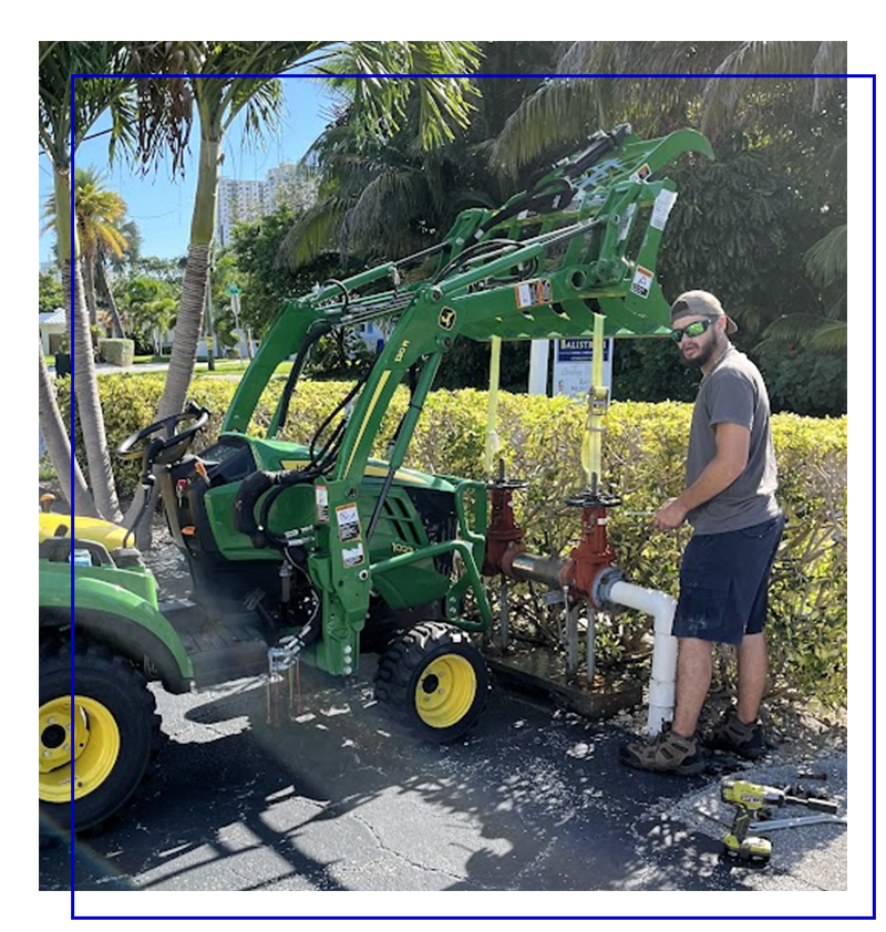 Plumber operating a green tractor with backflow prevention equipment in Tamarac, FL, ensuring water safety and compliance.