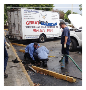 Great American Plumbing technicians performing drain cleaning services on-site in Cooper City, Florida, with service truck in background.