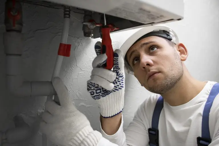 Plumber repairing water heater, emergency plumbing services in Pembroke Pines, FL.