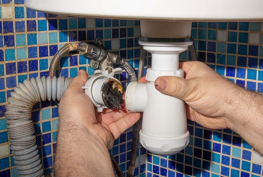 Clogged drain pipe with debris, Coral Springs plumbing repair.