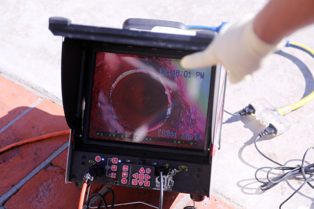 Sewer camera inspection device displaying pipe footage for Parkland homeowners.