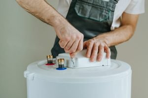 Plumber installing water heater, tankless water heater replacement