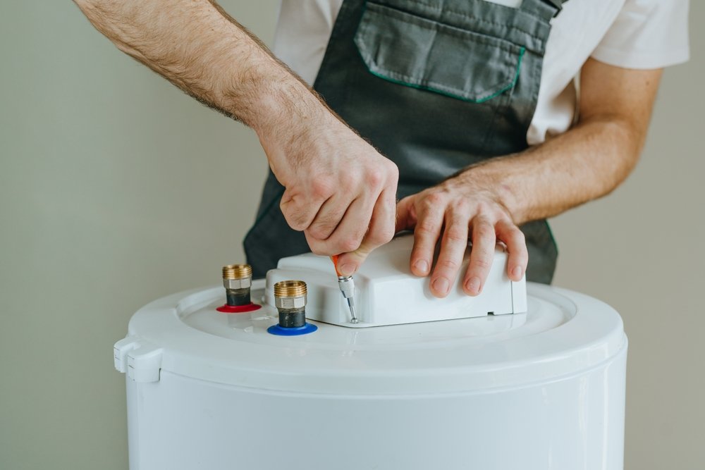 Plumber installing water heater, tankless water heater replacement